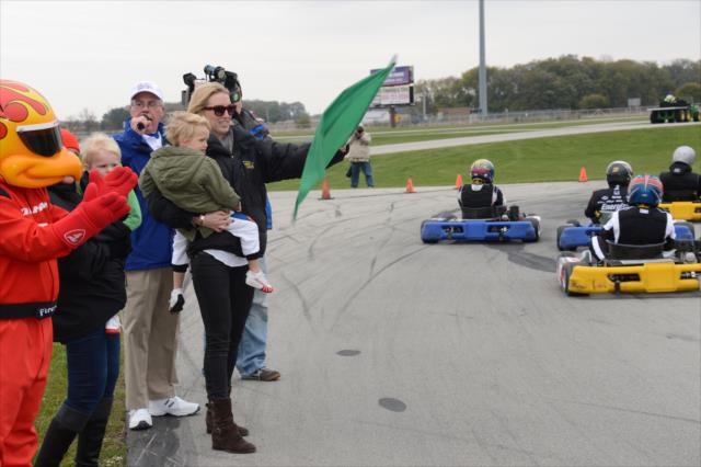 Susie Wheldon waves the green flag to start the Dan Wheldon Pro-Am Karting Classic at New Castle Motorsports Park -- Photo by: Chris Owens