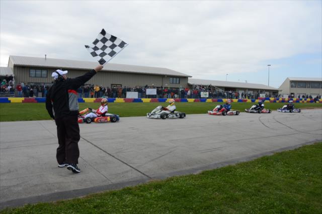 Drivers take the checkered flag to complete an opening stage at the Dan Wheldon Pro-Am Karting Classic -- Photo by: Chris Owens