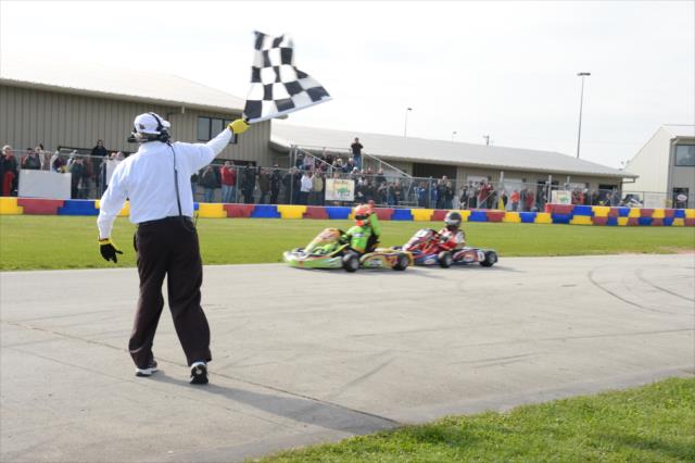 James Hinchcliffe takes the checkered flag over Zach Veach in one segment of the Dan Wheldon Pro-Am Karting Classic -- Photo by: Chris Owens