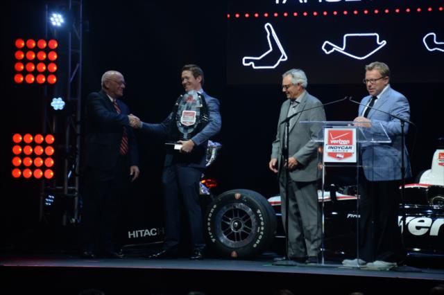 Scott Dixon is presented the 3rd Place trophy by Derrick Walker during the 2014 INDYCAR Championship Celebration -- Photo by: John Cote