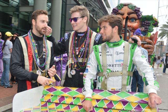 James Hinchcliffe, Josef Newgarden, and Carlos Munoz discuss their bead throwing strategies before the Krewe of Bacchus Mardi Gras parade in New Orleans -- Photo by: Chris Owens