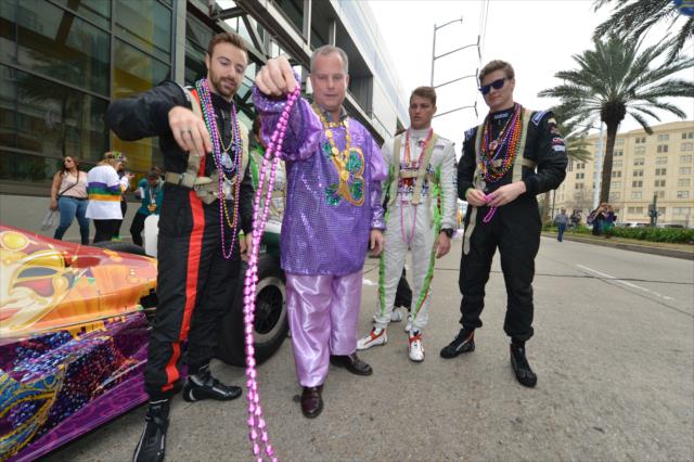 James Hinchcliffe learns how to throw beads from Bacchus Capt. Clark Brennan before the Mardi Gras parade in New Orleans as Sage Karam & Josef Newgarden look on -- Photo by: Chris Owens