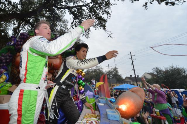 Sage Karam and Neil Alberico toss beads to the Mardi Gras crowd during the Krewe of Bacchus Mardi Gras parade in New Orleans -- Photo by: Chris Owens