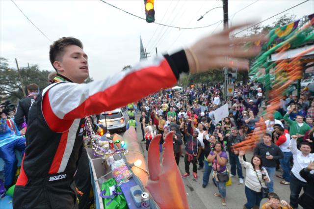 USF2000 driver Aaron Telitz tosses beads to the Mardi Gras crowd during the Krewe of Bacchus Mardi Gras parade in New Orleans -- Photo by: Chris Owens