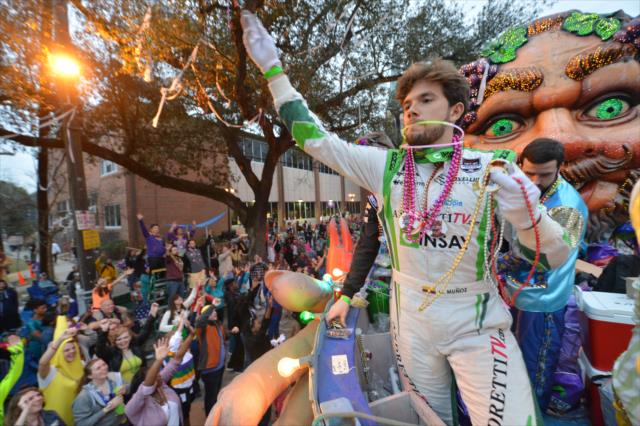 Carlos Munoz tosses beads to the Mardi Gras crowd during the Krewe of Bacchus prade in New Orleans -- Photo by: Chris Owens