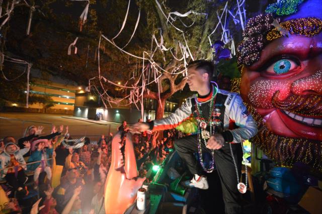 USF2000 driver Aaron Telitz tosses beads to the revelers during the Krewe of Bacchus Mardi Gras parade in New Orleans -- Photo by: Chris Owens