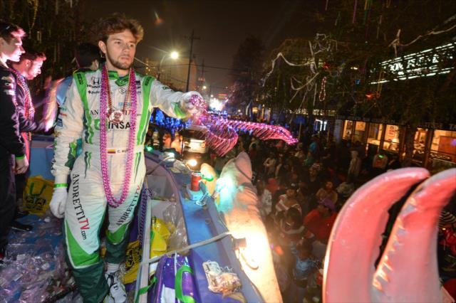 Carlos Munoz tosses beads to the revelers during the Krewe of Bacchus Mardi Gras parade in New Orleans -- Photo by: Chris Owens