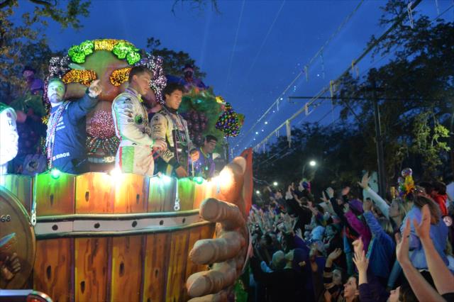 James Hinchcliffe, Sage Karam, and Neil Alberico toss beads to the Mardi Gras revelers in New Orleans -- Photo by: Chris Owens