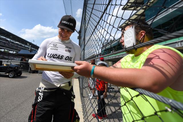 Robert Wickens signs an autograph along pit lane following his qualification attempt for the 102nd Indianapolis 500 at the Indianapolis Motor Speedway -- Photo by: James  Black