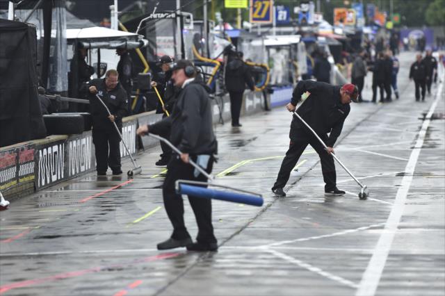 Crews sweep away puddles of water on pit lane during qualifications for Race 2 of the Chevrolet Detroit Grand Prix at Belle Isle Park -- Photo by: Chris Owens