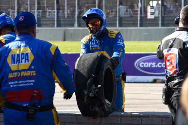 An Andretti Autosport crewman removes the destroyed tire of Alexander Rossi off pit lane during Race 2 of the Chevrolet Detroit Grand Prix at Belle Isle Park -- Photo by: James  Black