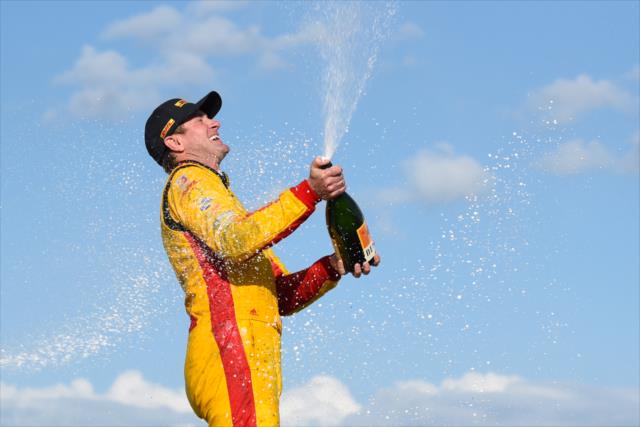 Ryan Hunter-Reay sprays the champagne in Victory Circle after winning Race 2 of the Chevrolet Detroit Grand Prix at Belle Isle Park -- Photo by: James  Black