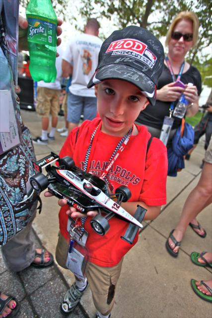 A young fan shows off his autographed Will Power diecast -- Photo by: Shawn Gritzmacher