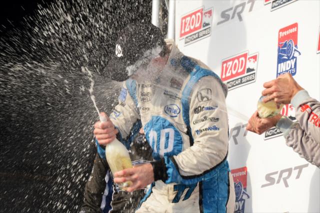 Simon Pagenaud gets a champagne shower on the podium in Baltimore -- Photo by: Chris Owens