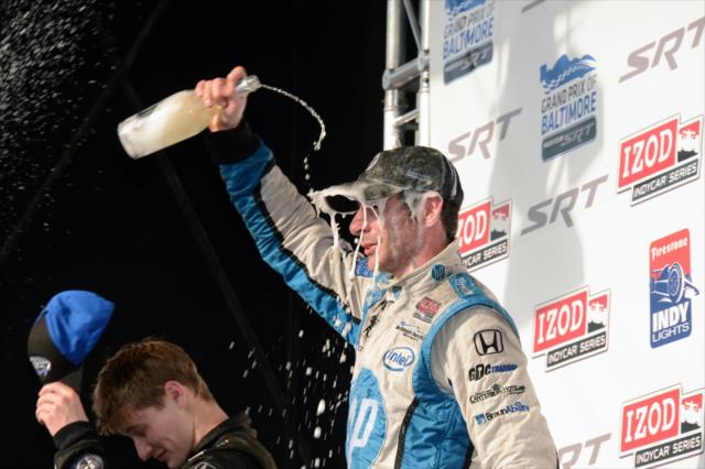 Simon Pagenaud showers himself in champagne during post-race festivities for the 2013 Grand Prix of Baltimore -- Photo by: Chris Owens