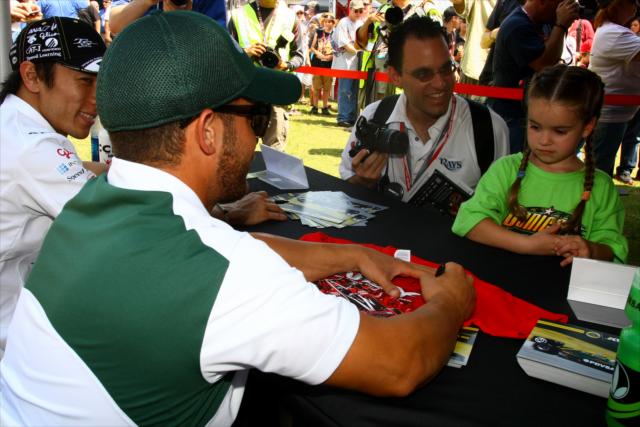 EJ Viso signing autographs for a young fan -- Photo by: Dan Helrigel