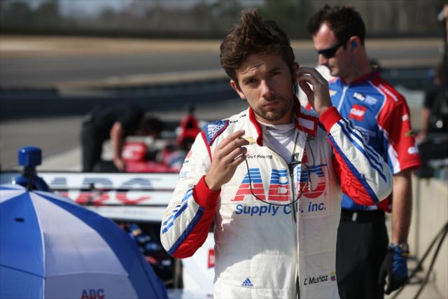 Carlos Munoz prepares his earpieces along pit lane prior to track activity during the open test at Barber Motorsports Park -- Photo by: Chris Jones