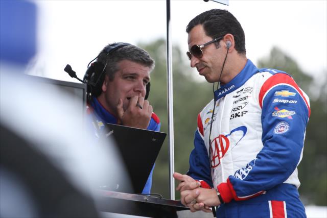 Helio Castroneves chats with one of his engineers prior to qualifications for the Honda Indy Grand Prix of Alabama -- Photo by: Joe Skibinski
