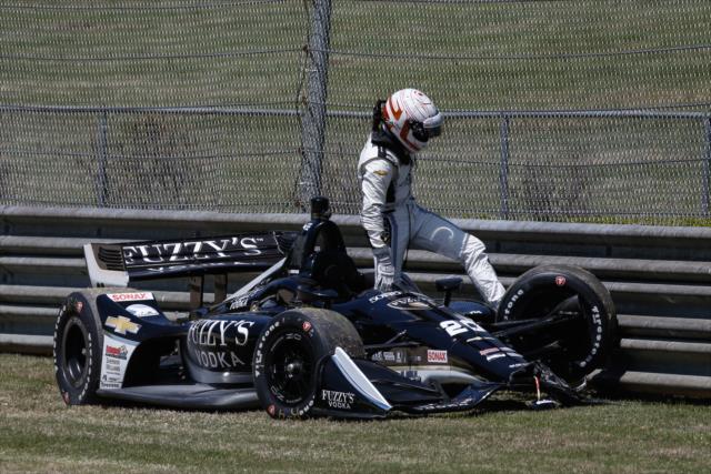 Jordan King climbs from his wounded car after contact exiting Turn 2 during practice for the Honda Indy Grand Prix of Alabama -- Photo by: Joe Skibinski