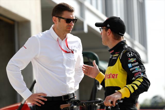 Sebastien Bourdais chats with race director Kyle Novak along pit lane prior to qualifications for the Honda Indy Grand Prix of Alabama -- Photo by: Joe Skibinski