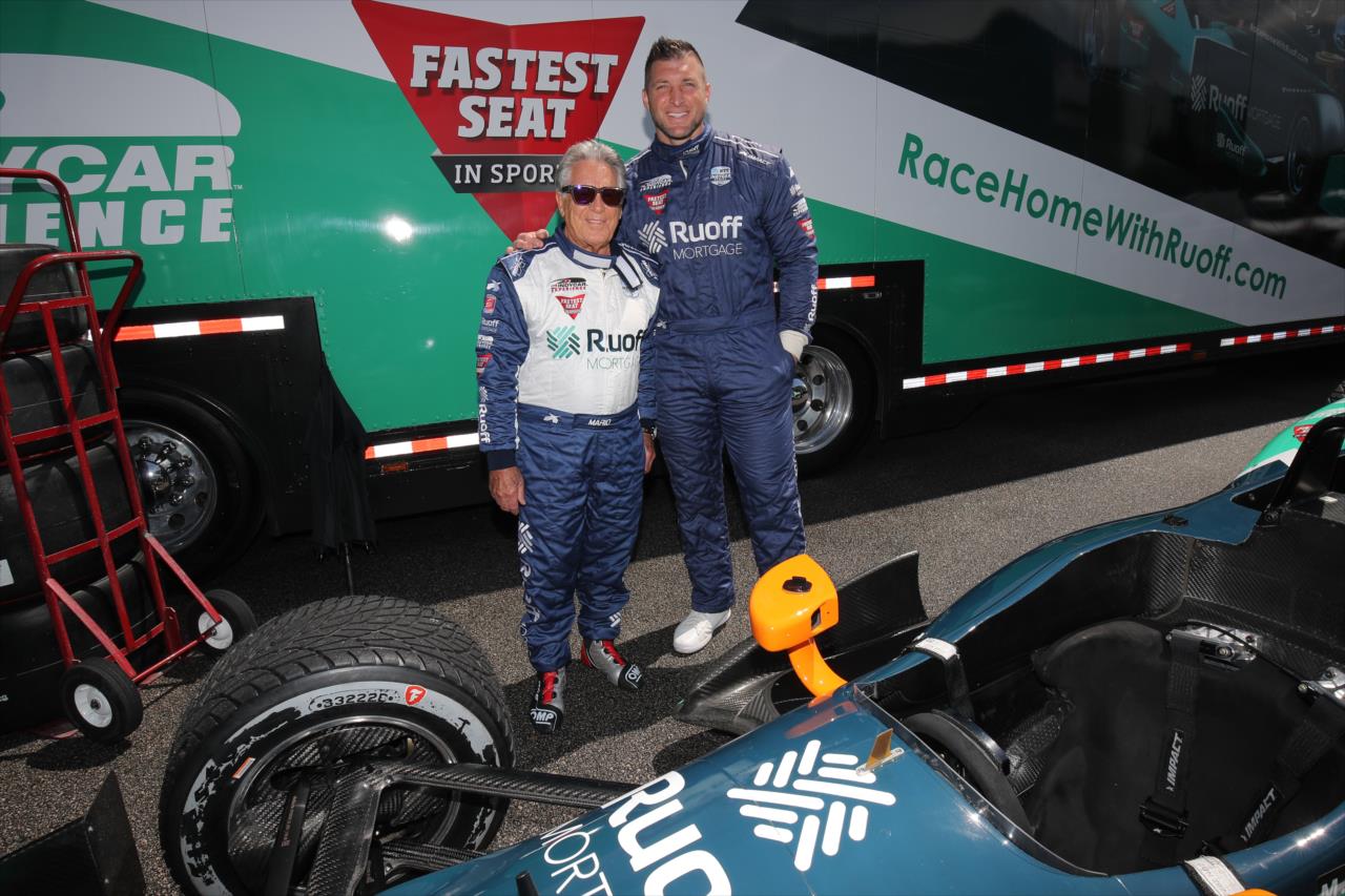 Tim Tebow with Mario Andretti prior to riding in the Ruoff Fastest Seat in Sports - Honda Indy Grand Prix of Alabama - By: Chris Jones -- Photo by: Joe Skibinski