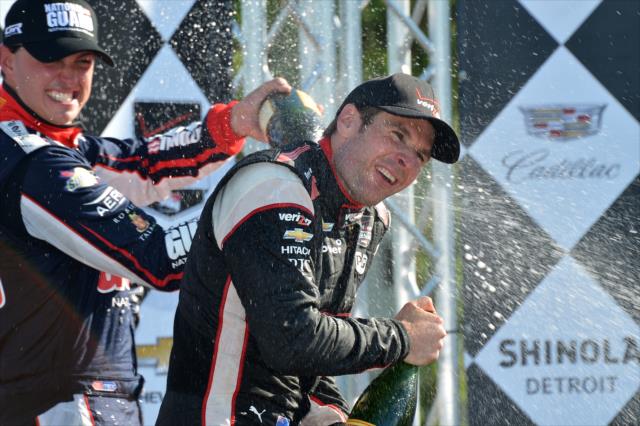 Graham Rahal and Will Power spray the champagne on the podium for Race 1 of the Chevrolet Indy Dual in Detroit -- Photo by: Chris Owens