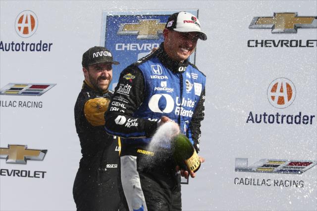 Graham Rahal and James Hinchcliffe spray the champagne in Victory Circle following Race 1 of the Chevrolet Detroit Grand Prix -- Photo by: Bret Kelley