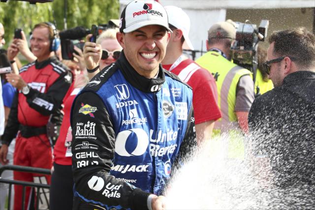 Graham Rahal sprays the champagne in Victory Circle after winning Race 1 of the Chevrolet Detroit Grand Prix -- Photo by: Bret Kelley