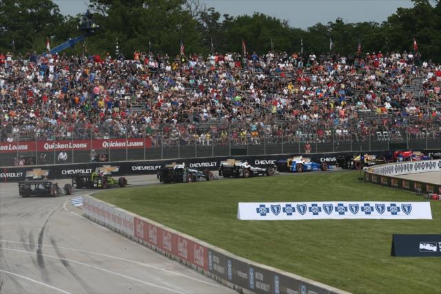 The field streams through Turn 1 at the start of Race 1 of the Chevrolet Detroit Grand Prix -- Photo by: Chris Jones