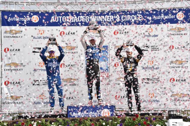 The confetti flies over Victory Circle as Graham Rahal, Scott Dixon, and James Hinchcliffe hoist their trophies following Race 1 of the Chevrolet Detroit Grand Prix -- Photo by: Chris Owens