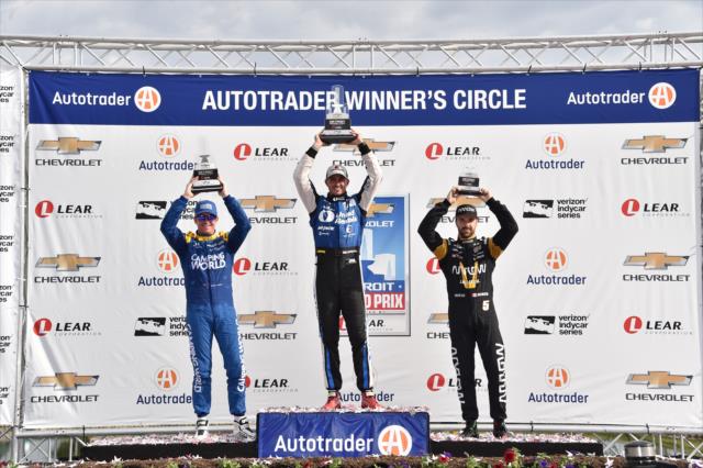 Graham Rahal, Scott Dixon, and James Hinchcliffe hoist their trophies following Race 1 of the Chevrolet Detroit Grand Prix -- Photo by: Chris Owens