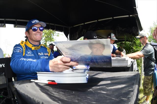Scott Dixon signs a hero card during the autograph session at Belle Isle Park in Detroit -- Photo by: Chris Owens