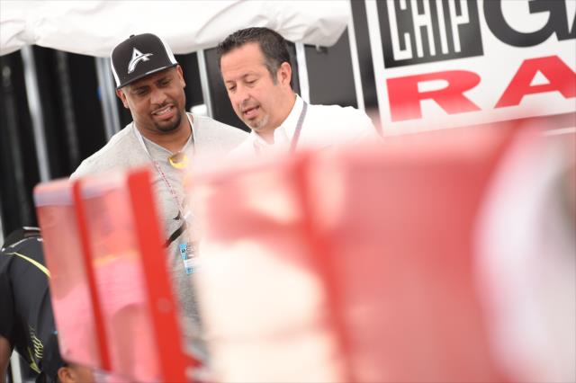 LaMarr Woodley chats with a member of Chip Ganassi Racing in their paddock at Detroit Belle Isle -- Photo by: Chris Owens