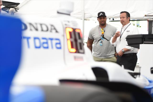 LaMarr Woodley chats with a member of Chip Ganassi Racing in their paddock at Belle Isle Park -- Photo by: Chris Owens