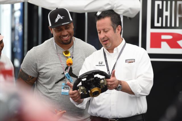 LaMarr Woodley looks over a steering wheel in the Chip Ganassi Racing paddock at Belle Isle Park in Detroit -- Photo by: Chris Owens