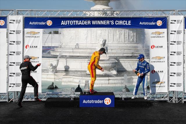 The podium of Ryan Hunter-Reay, Will Power, and Ed Jones spray the champagne in Victory Circle following Race 2 of the Chevrolet Detroit Grand Prix at Belle Isle Park -- Photo by: Joe Skibinski