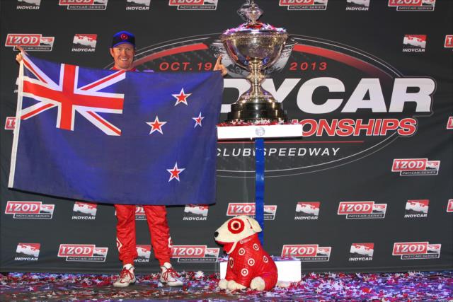 Scott Dixon proudly displays the flag of New Zealand as the 2013 IZOD IndyCar Series champion -- Photo by: Chris Jones