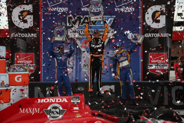 The podium of Graham Rahal, Tony Kanaan, and Marco Andretti hoist their trophies in Victory Lane following the MAVTV 50 at Auto Club Speedway -- Photo by: Chris Jones