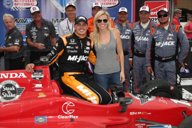 Graham Rahal with his fiance, Courtney Force, and his team following their win in the MAVTV 500 at Auto Club Speedway -- Photo by: Chris Jones