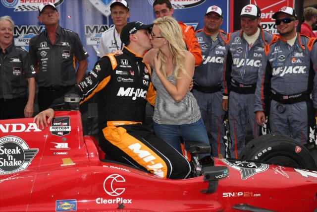 Graham Rahal with a kiss from his fiance, Courtney Force, following his win in the MAVTV 500 at Auto Club Speedway -- Photo by: Chris Jones