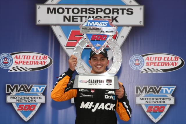 Graham Rahal with the winner's trophy in Victory Lane following his win in the MAVTV 500 at Auto Club Speedway -- Photo by: Chris Jones