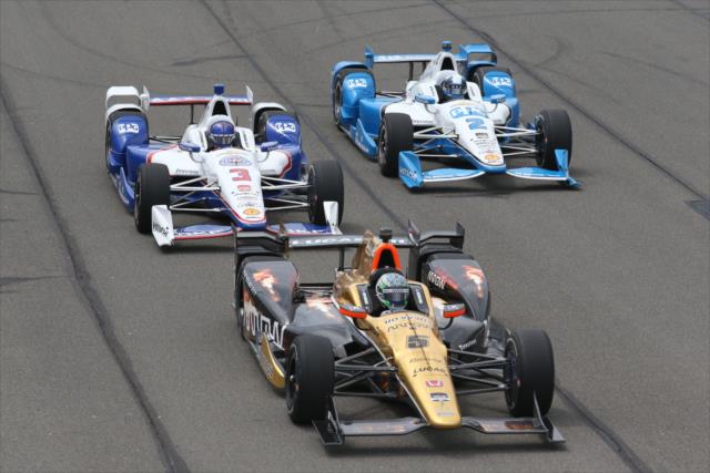 Ryan Briscoe leads Helio Castroneves and Juan Pablo Montoya down the frontstretch during the MAVTV 500 at Auto Club Speedway -- Photo by: Chris Jones