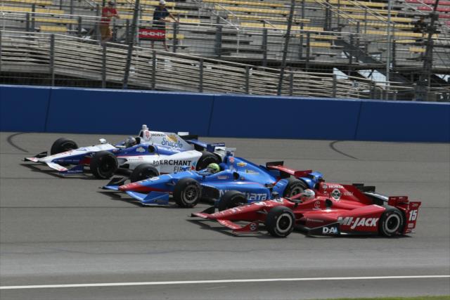 Marco Andretti, Tony Kanaan, and Graham Rahal go three-wide down the frontstretch during the MAVTV 500 at Auto Club Speedway -- Photo by: Chris Jones