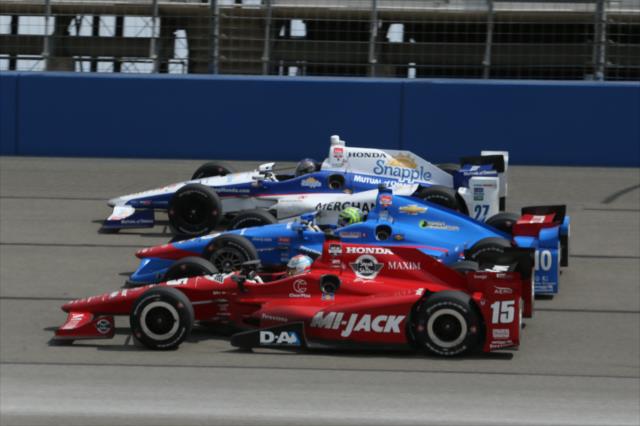 Marco Andretti, Tony Kanaan, and Graham Rahal go three-wide going into Turn 1 during the MAVTV 500 at Auto Club Speedway -- Photo by: Chris Jones