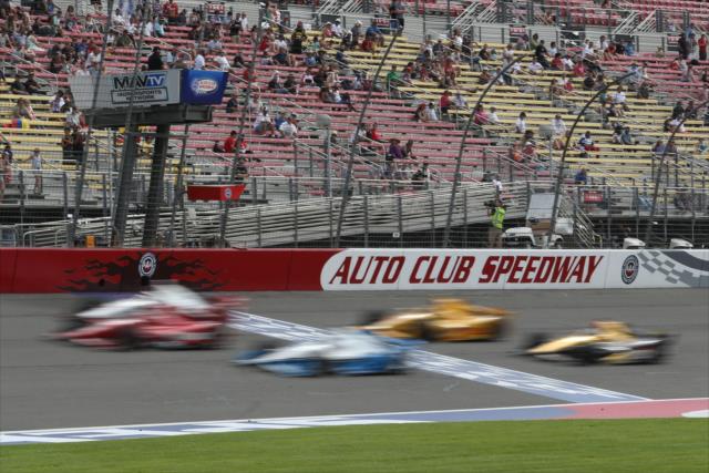 The field flashes across the start/finish line during the MAVTV 500 at Auto Club Speedway -- Photo by: Chris Jones