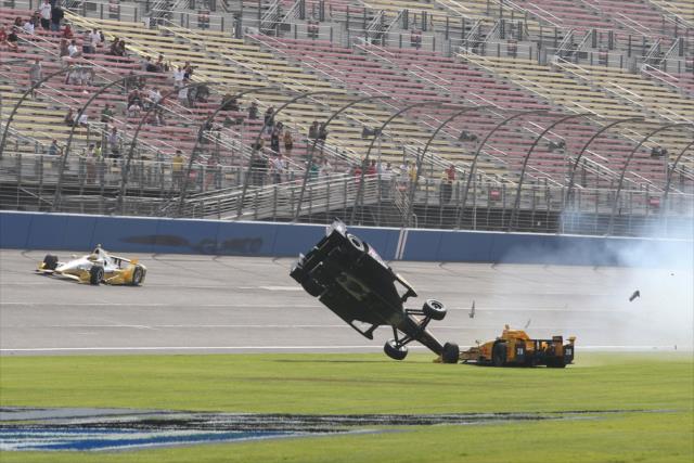 Ryan Briscoe and Ryan Hunter-Reay slide through the grass at the conclusion of the MAVTV 500 at Auto Club Speedway -- Photo by: Chris Jones