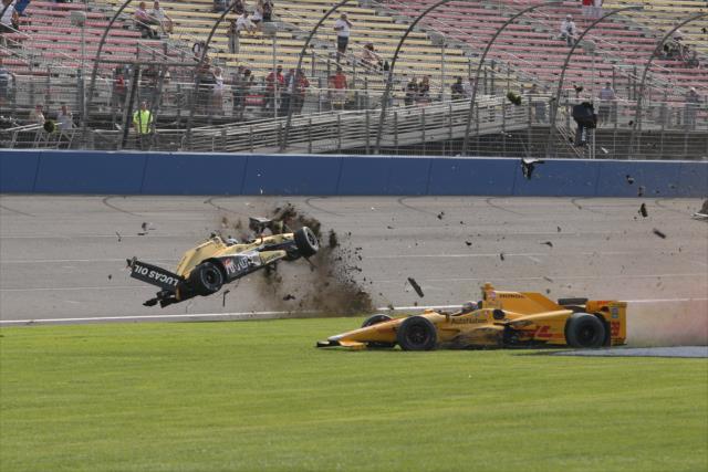 Ryan Briscoe and Ryan Hunter-Reay fly through the grass at the conclusion of the MAVTV 500 at Auto Club Speedway -- Photo by: Chris Jones