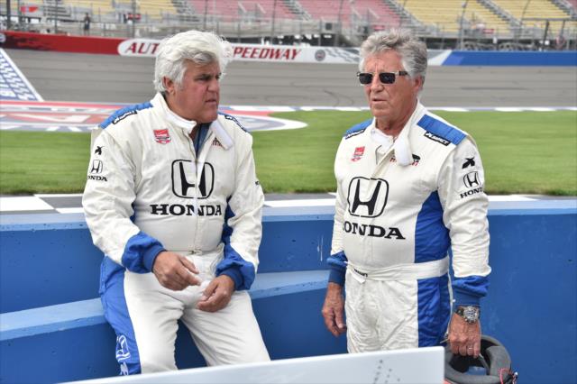 Jay Leno and Mario Andretti chat on pit lane prior to their two-seater ride at Auto Club Speedway -- Photo by: Chris Owens