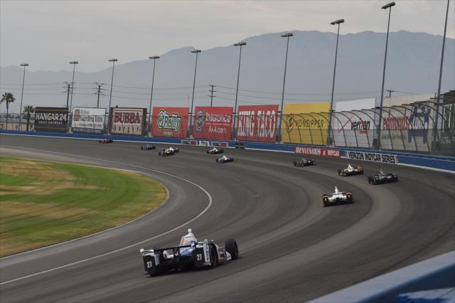 The field streams through Turns 1 and 2 during the MAVTV 500 at Auto Club Speedway -- Photo by: Chris Owens