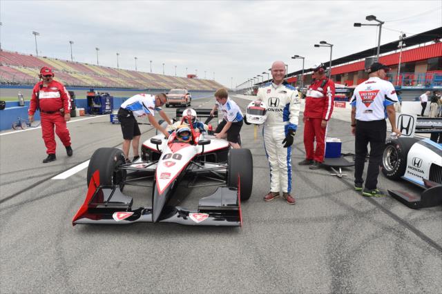 Rick Woolstenhulme Jr., drummer for Lifehouse, poses next to an IndyCar Two-Seater at Auto Club Speedway -- Photo by: Chris Owens